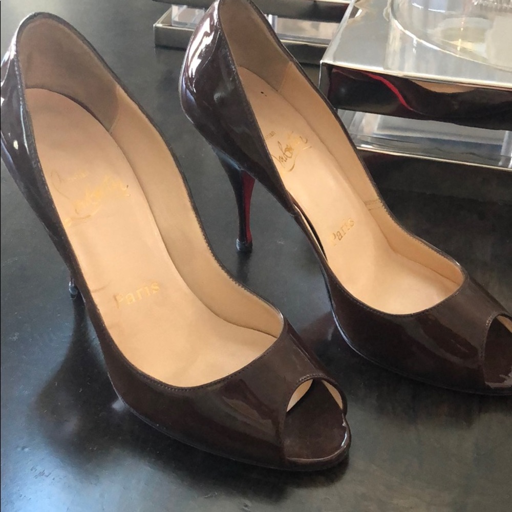 Brown patent Christian Louboutin peep toe heels.